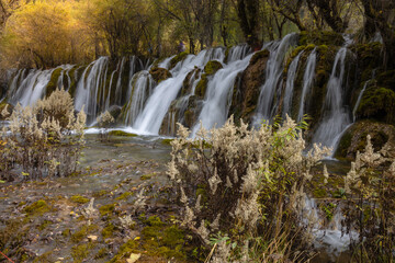 The  Arrow Bamboo Lake Waterfall in Jiuzhaigou National Park is a famous tourist attraction in Sichuan, especially during the autumn leaves season, China