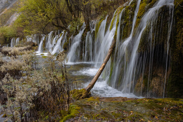 The  Arrow Bamboo Lake Waterfall in Jiuzhaigou National Park is a famous tourist attraction in Sichuan, especially during the autumn leaves season, China