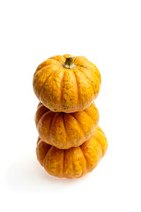 Three stacked orange pumpkins with textured skin, showcasing vibrant autumn colors, perfect for seasonal decorations and culinary uses, representing harvest time and festive spirit
