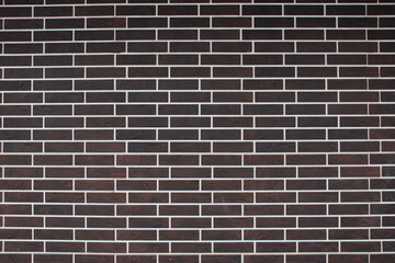 Dark brick wall with white grout lines in a modern architectural setting