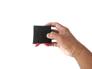 Hand holding a gift box wrapped with a red ribbon on a white background. Black Friday