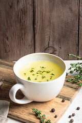 Hot healing bouillon (chicken bone broth) with herbs