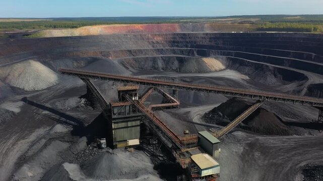 Aerial drone footage of a large open-pit coal mine operation.