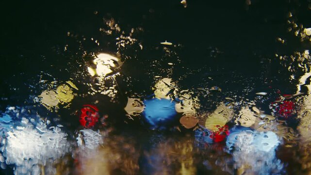 rainy or snowy colorful traffic bokeh city at nigh windscreen blurred background