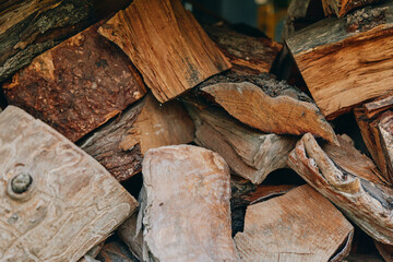 Firewood stacked logs chopped wood wood texture birch logs rustic timber closeup, rough bark and grain details in a cozy autumn pile for fireplace fuel, cabin heating and lifestyle scenes