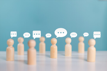 Wooden human figures with speech bubble of message and chatting. Social media interaction and chat concept