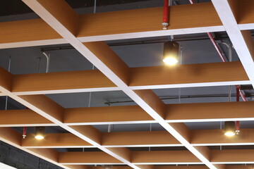Modern architectural ceiling design with wooden beams and recessed lighting