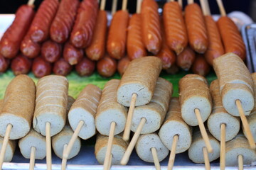 Delicious Korean street food: sausages and fish cakes on skewers