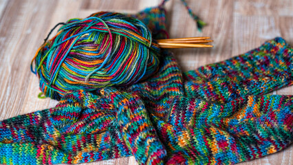colorful knitting yarn and knitting needles, knitwear fashion, wool socks and needles, knitting hobby, handcraft clothing, handcraft concept