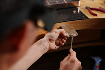 Artisan's Delicate Touch: An artisan meticulously works on a delicate piece, utilizing specialized tools and precise movements, demonstrating skill and dedication in craft.