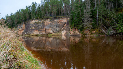 beautiful view of sandstone outcrops on the riverbank, autumn landscape, reflections in the river