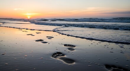 Footprints on wet sand at sunset beach