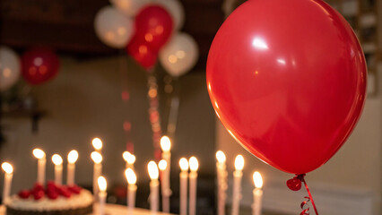 red bauble near warm candlelight