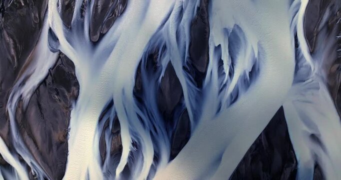 Cinematic top-down visuals reveal Iceland’s Skeiðarársandur as a living artwork, with glacial rivers spreading like luminous roots across a vast, starkly beautiful volcanic desert.