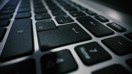 Macro closeup of pressing the enter key on a laptop keyboard, showing tactile action and modern computer interface