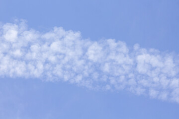Blue sky with clouds. Altocumulus or Cirrocumulus clouds formation in the atmosphere.