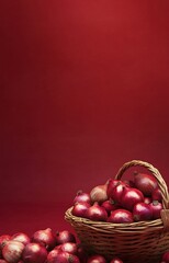 Vibrant red onions in basket on maroon background