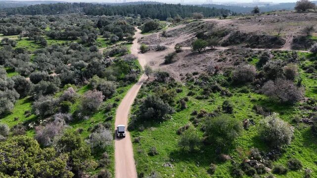 Aerial 4K footage of Ben Shemen Forest in central Israel, featuring the iconic &ldquo;Chinese House&rdquo; structure surrounded by dense Mediterranean woodland. The drone captures sweeping views of green pine tre