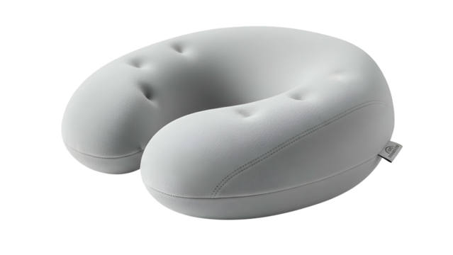 Light grey ergonomic U-shaped travel pillow with button accents, on a black background