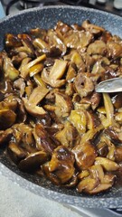 Cooked mushrooms in a pan glistening with sauce and ready to serve