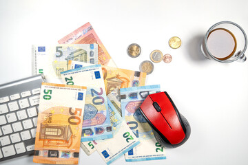 computer mouse with euro banknotes and keyboard on desk