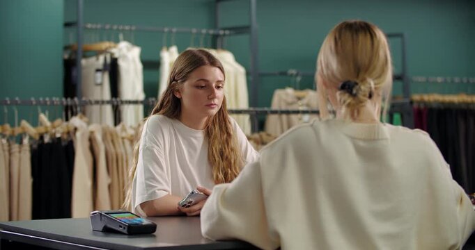 Customer paying at checkout in clothing store