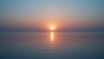 Fototapeta premium Soft sunrise glow reflecting on a smooth glass surface