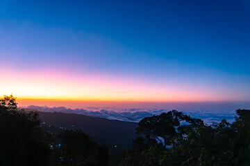 Vibrant Sunrise Over a Sea of Clouds and Mountain Peaks