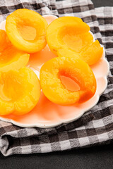 Peach canned fruit in own juice tasty snack fresh delicious gourmet food background on the table rustic food top view copy space keto and paleo diet vegetarian and vegan food