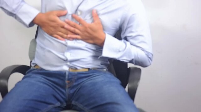 Man holding chest, heart attack, shortness of breath, heart disease, panic attack, health problems at night, stress at home. Emergency conditions. Emergency aid for heart disease