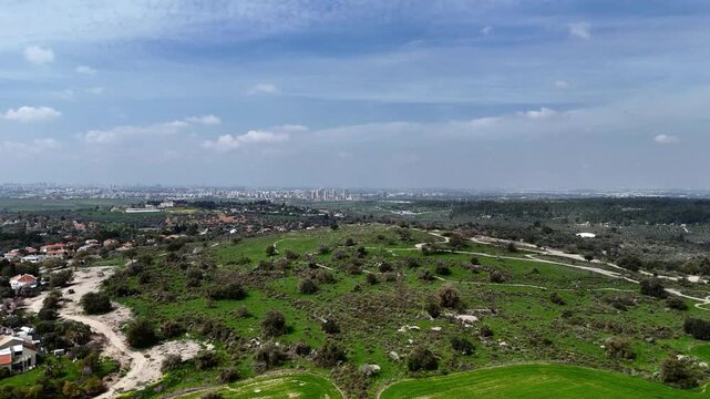 Aerial 4K footage of Ben Shemen Forest in central Israel, featuring the iconic &ldquo;Chinese House&rdquo; structure surrounded by dense Mediterranean woodland. The drone captures sweeping views of green pine tre