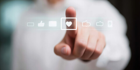 Finger pressing heart button on a digital interface, symbolizing online liking, interaction, and positive feedback in applications