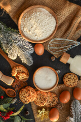Festive baking ingredients and cookies arranged on a rustic surface