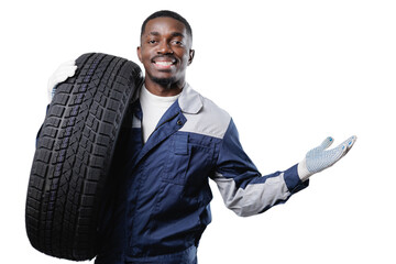 African male auto mechanic holding tire and smiling confidently on isolated white background