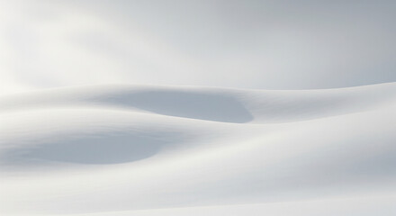  Pristine, untouched snow covering rolling hills under a vast, soft grey winter sky. The landscape is minimalist, with subtle undulations and gentle shadows. No trees or specific features, just a sere