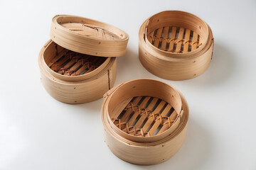 Three Empty Bamboo Steamer Baskets on White Background