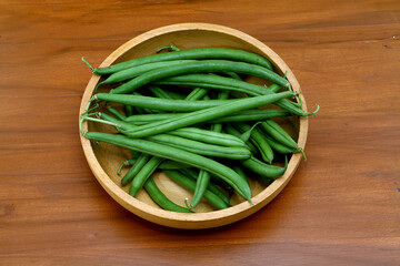 Fresh french beans in wooden bowl,close up