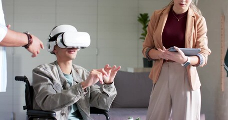 Man in wheelchair wearing VR headset exploring interface, colleagues guiding on tablet in office - Powered by Adobe