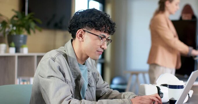 Diverse coworkers typing on laptop and exchanging smile in office after woman powering keyboard