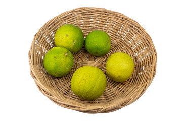 Fresh organic green lemon in a wicker basket ready for a healthy autumn harvest diet