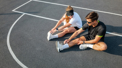 Stretching exercise routine on a basketball court