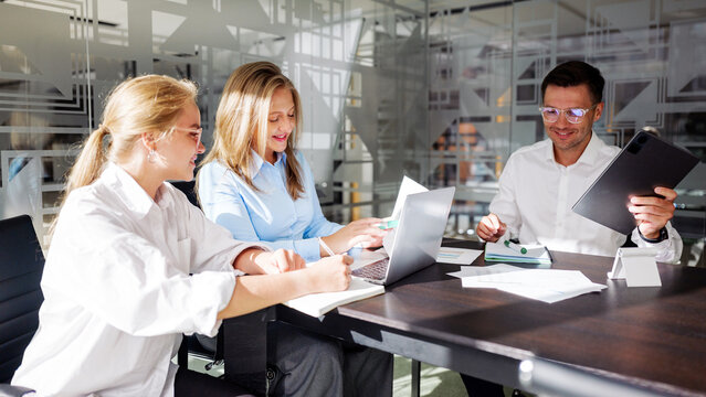 Team members collaborating on a project in a modern office