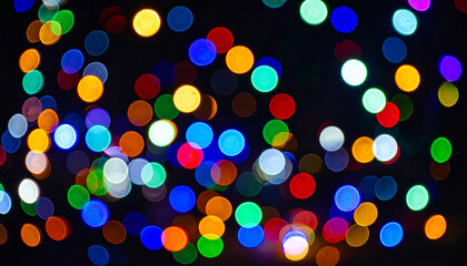 Vibrant bokeh lights of various colors create an abstract festive background. The defocused circular shapes offer a dazzling, celebratory atmosphere with space for text.
