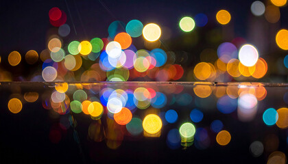 Vibrant bokeh lights of various colors create an abstract festive background. The defocused circular shapes offer a dazzling, celebratory atmosphere with space for text.
