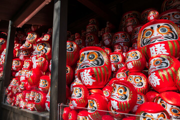 Daruma dolls in wooden cabinet decor at Katsuo-ji temple, Osaka