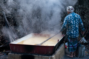 Rural Labor: A Man in Traditional Dress Working on the Jaggery Furnace