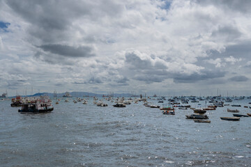 Atmospheric shot of the Arabian Sea harbor in Mumbai, India, under a heavily overcast sky. The...