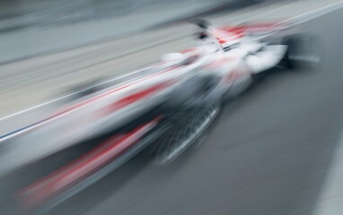 Motion blur of sports car at motorsports championship race.
