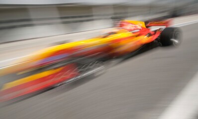 Motion blur of sports car at motorsports championship race.