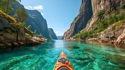 Kayaking on turquoise waters between majestic mountains under a bright blue sky. Explore nature through kayak